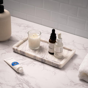 Cork & Mill marble tray on kitchen counter organizes oil bottles and soaps.