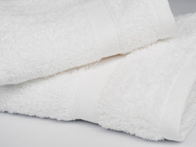 Towels neatly folded in a wardrobe display suitable for Airbnb refreshes.