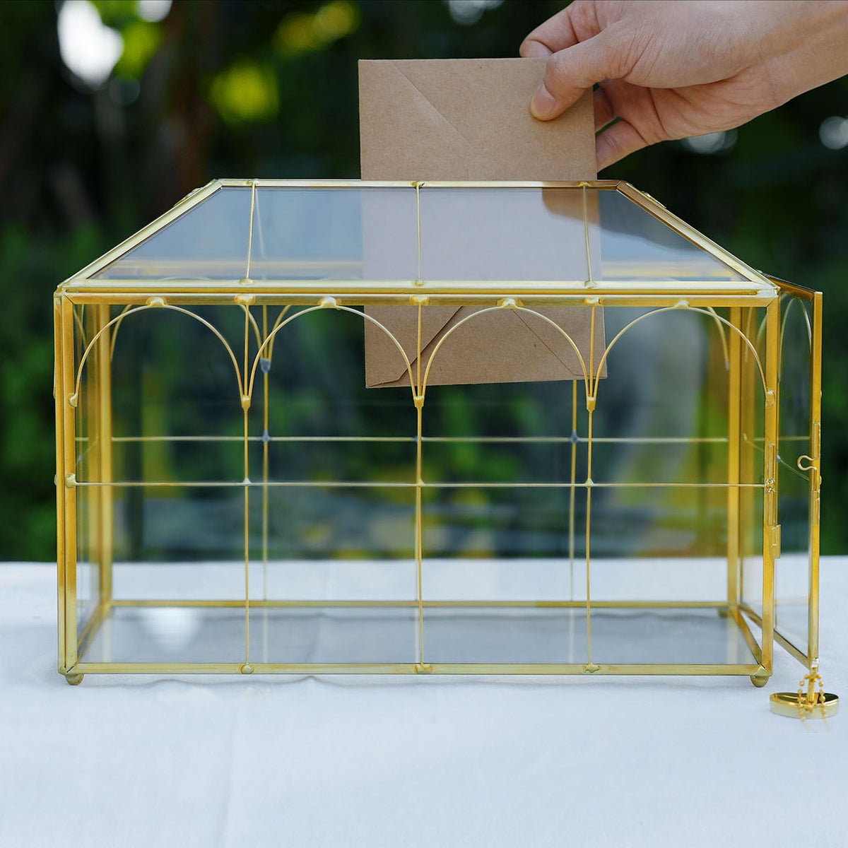 Corvanero gold-brass framed card box on a reception table for decor and storage.