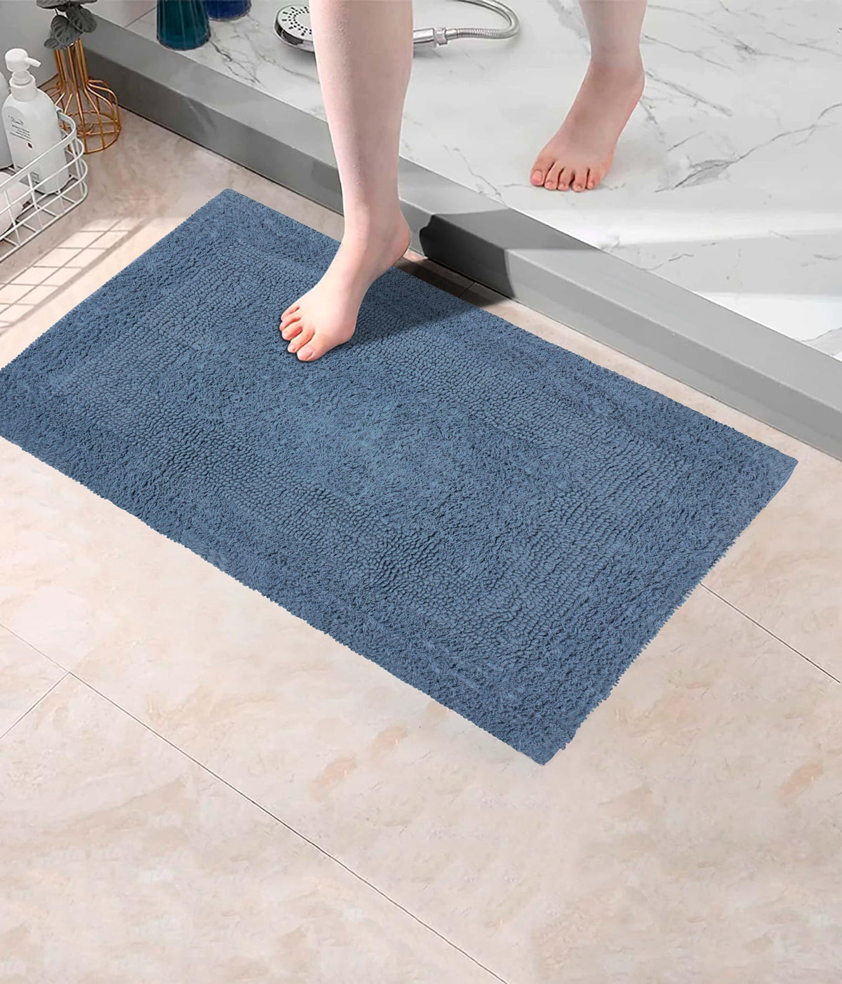 Cotton Craft Luxurious Bath Mat Azure Blue near tub edge for quick drying.