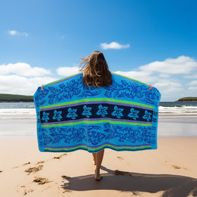 Cotton Craft towel spread on sand, offering full coverage for sunbathing.
