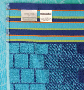 Cotton Craft soft high-pile towel ideal for poolside lounging.