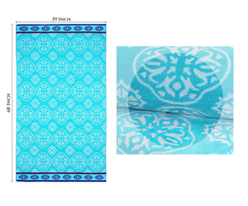 Cotton Craft towel on a lounge chair by water for sun-soaked relaxation.