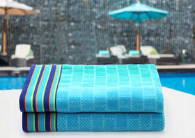 Cotton Craft two-pack beach towels laid flat for easy selection.