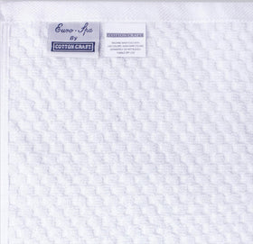 COTTON CRAFT white pack shot emphasizes spa-quality towels ready for guests.