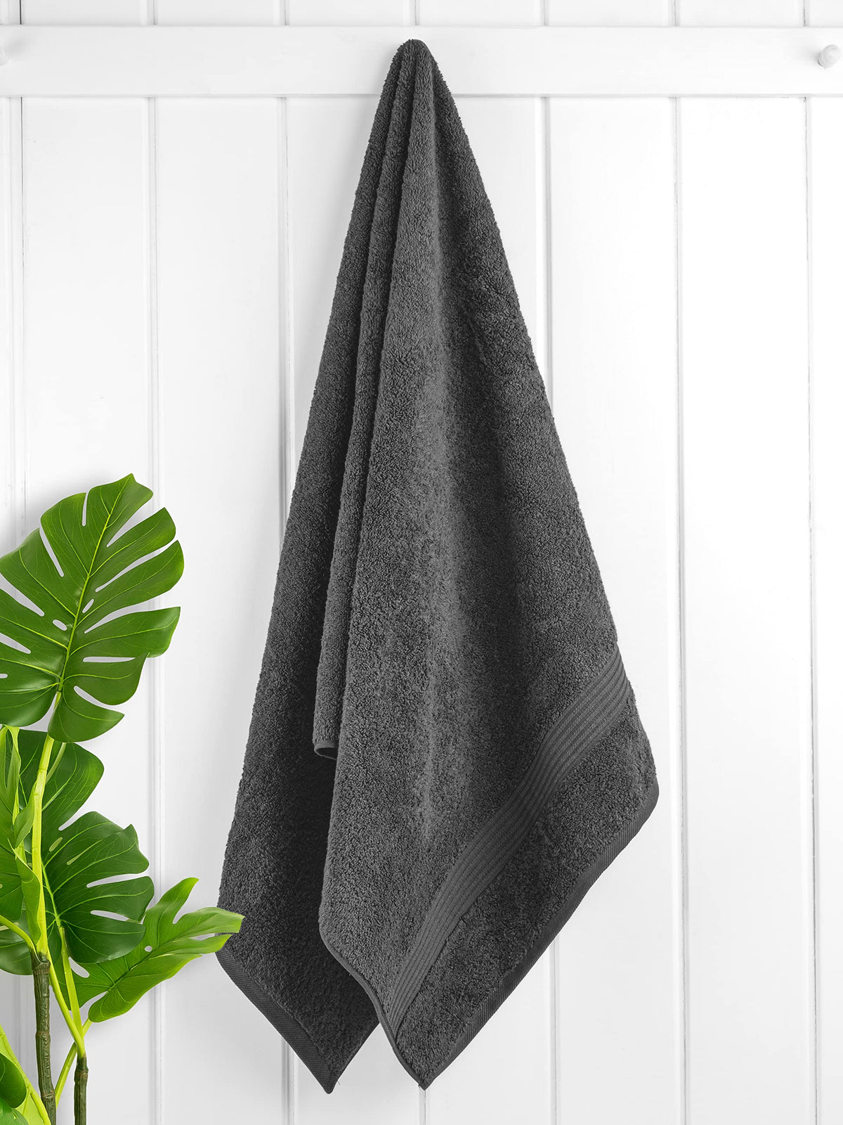 Cotton Paradise dark gray towels highlight soft, plush texture for a luxurious bathroom look.