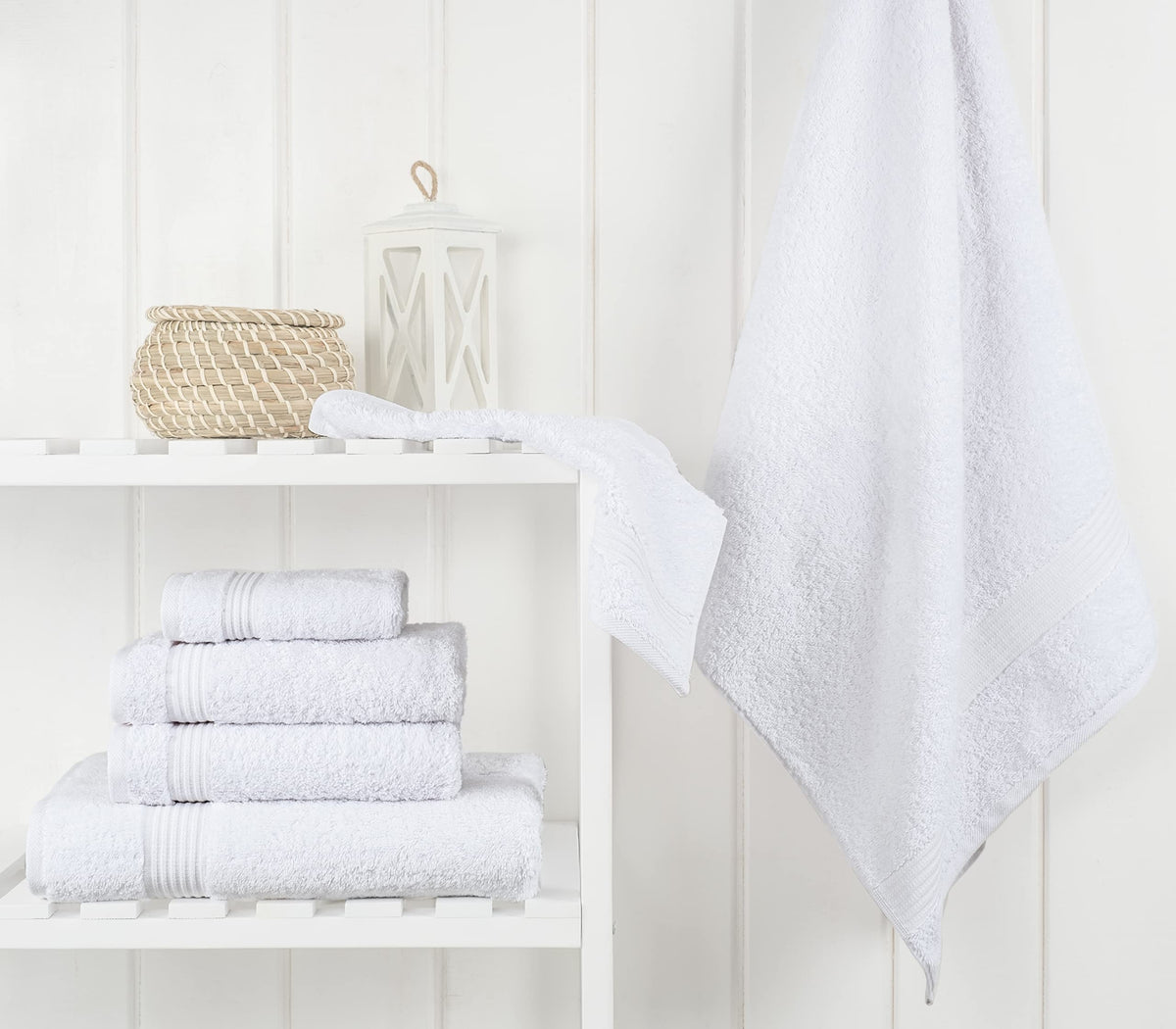 Snow white towels rolled together, highlighting the six-piece set.