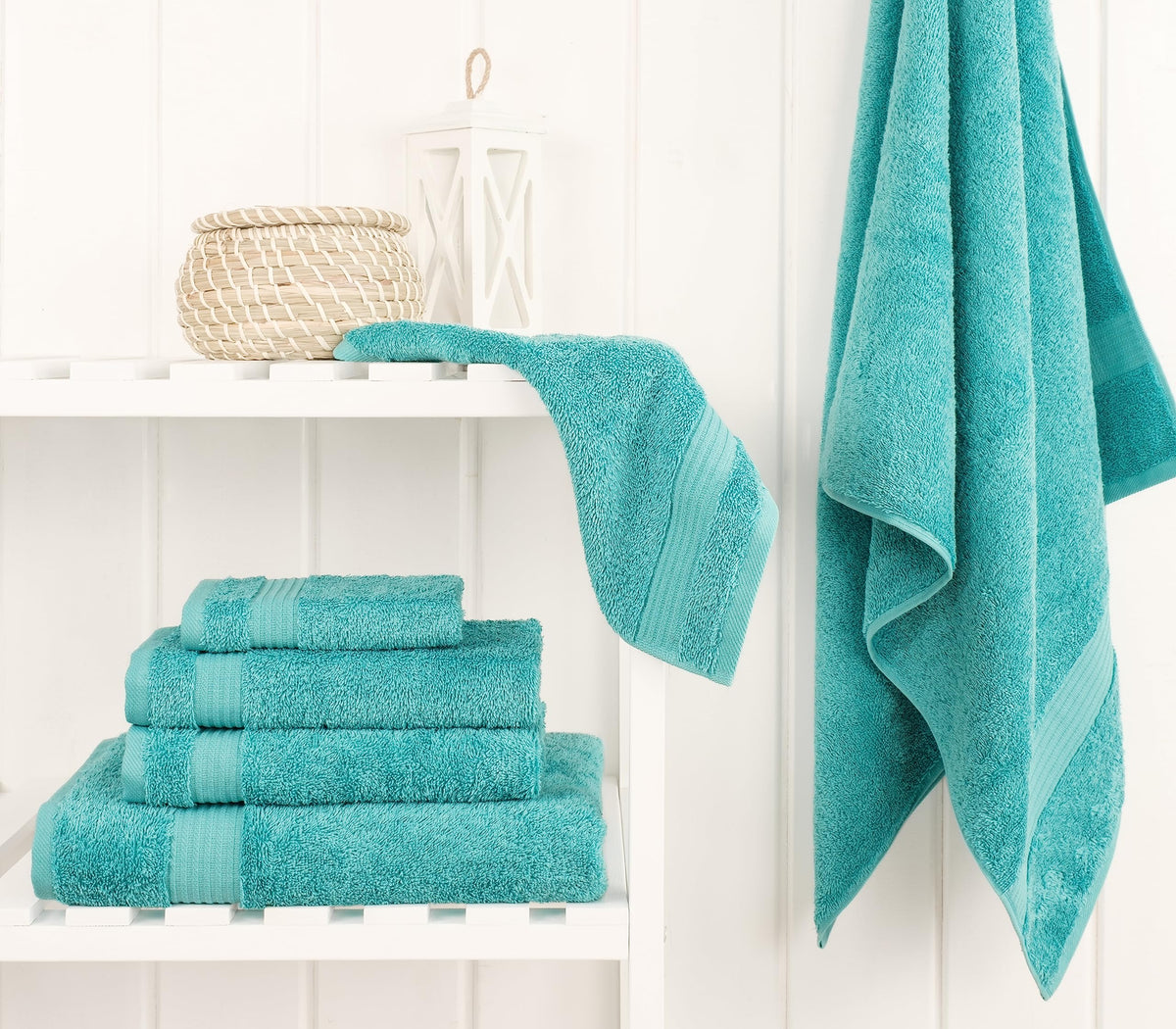 Cotton Paradise turquoise hand towels showing high absorbency for daily use.