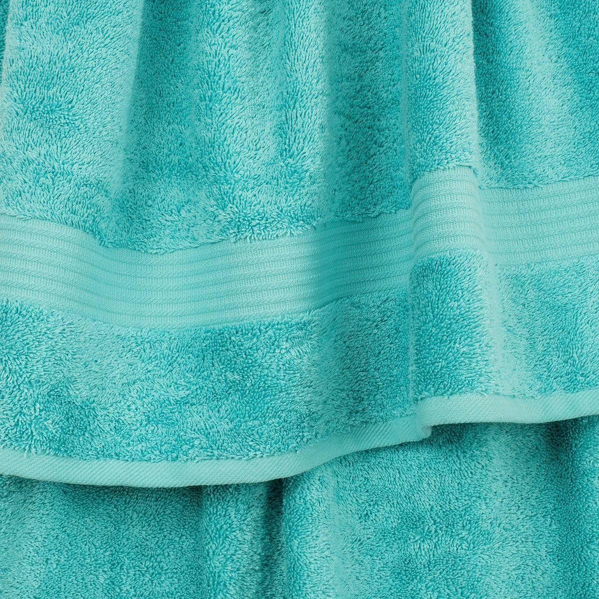 Cotton Paradise turquoise washcloths providing gentle cleansing with spa-like softness.