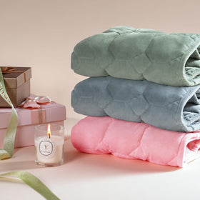 Cottonblue weighted blanket resting on a sofa adds warmth.