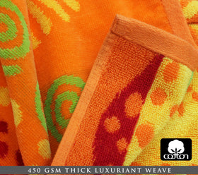Cotton Craft velour finish beach towel in sun colors; luxurious feel for lounging.