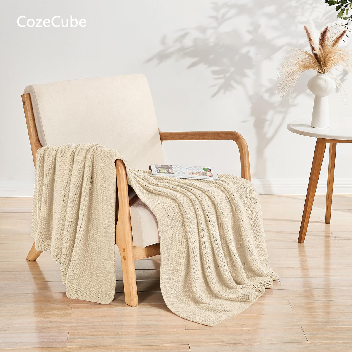 CozeCube beige throw draped on sofa adds timeless style and light warmth