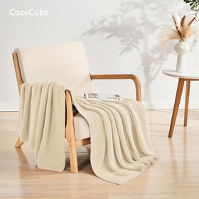 CozeCube beige throw draped on sofa adds timeless style and light warmth