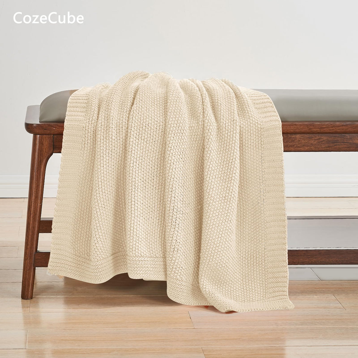 CozeCube beige throw folded on chair ready for quick cozy moments