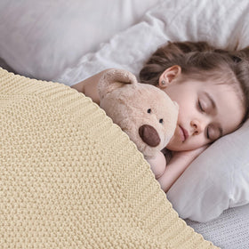 CozeCube beige throw for nap time on the sofa