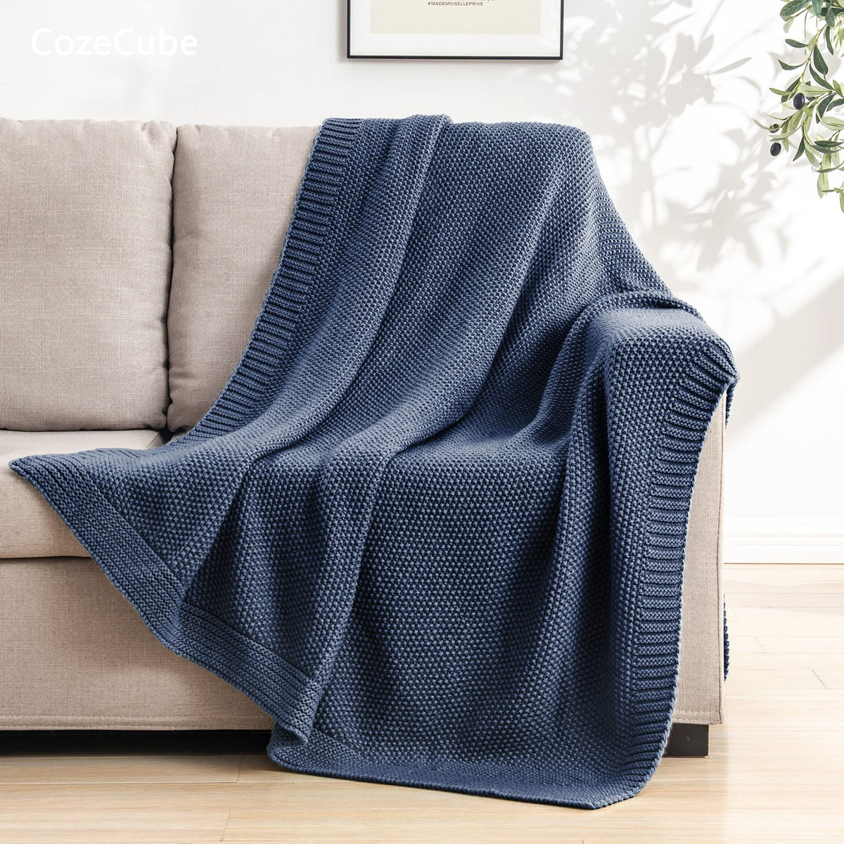 CozeCube blue throw draped over bed adds warm, inviting decor.