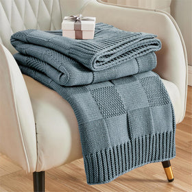 CozeCube dusty blue check knit throw adds warmth and style to the couch.