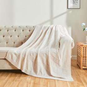 Folded CozeCube Check Knit Throw on sofa enhancing cozy decor