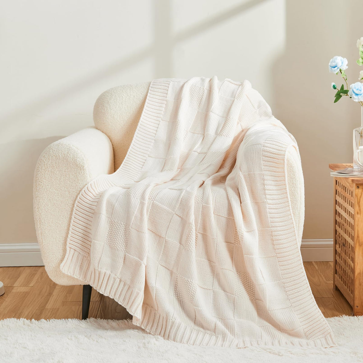 CozeCube Check Knit Throw draped over bed for decorative warmth