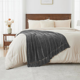 CozeCube throw draped over a bed for versatile warmth.