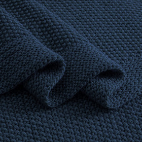 CozeCube navy blue care-and-wash closeup indicates machine washable convenience.