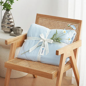 Cozy Bliss breathable summer blanket on bed delivering airy, cooling sensation.