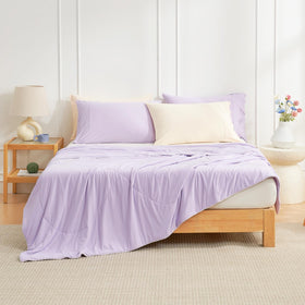 Cozy Bliss Cooling Comforter on bed side highlights lightweight cooling for summer nights.