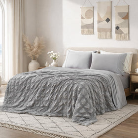 Cozy Bliss cooling comforter on king bed with seersucker plaid for refreshing nights.