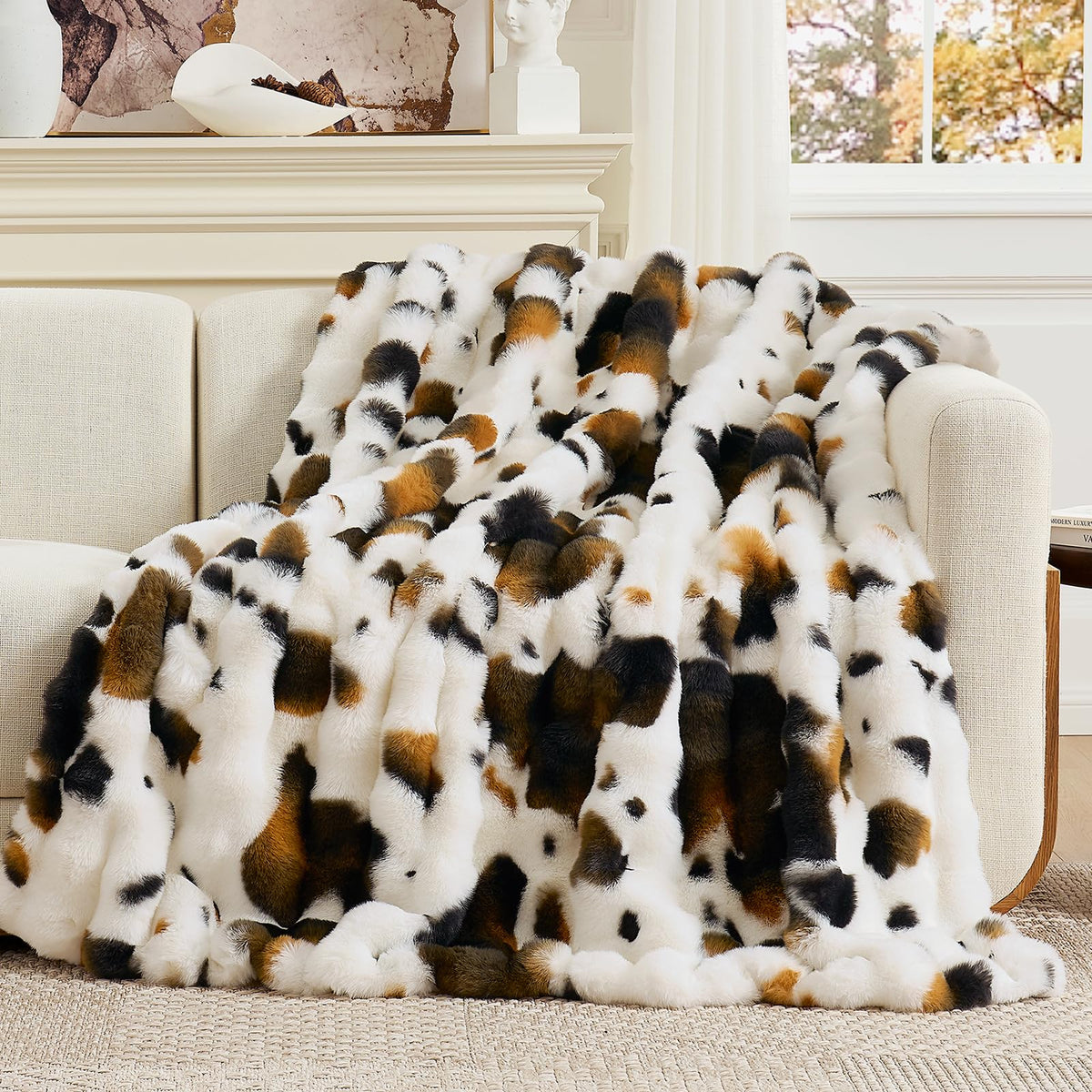 Cozy Bliss cow-print faux fur throw on a sofa adds chic warmth.