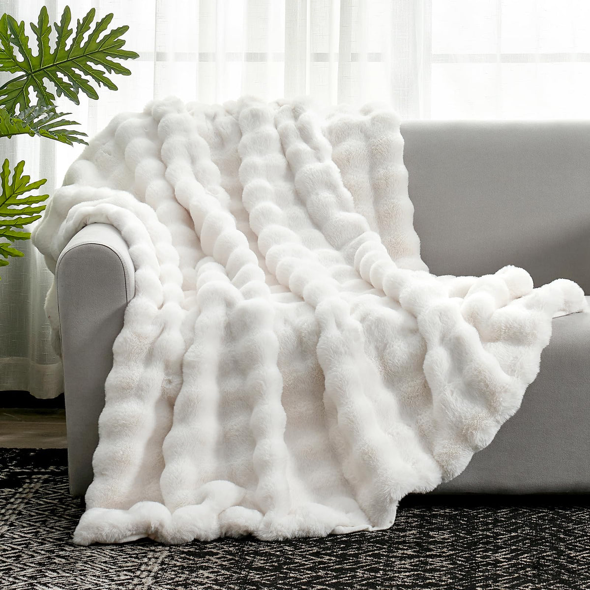 Cozy Bliss cream white 60x80 inch throw complements bedroom décor.