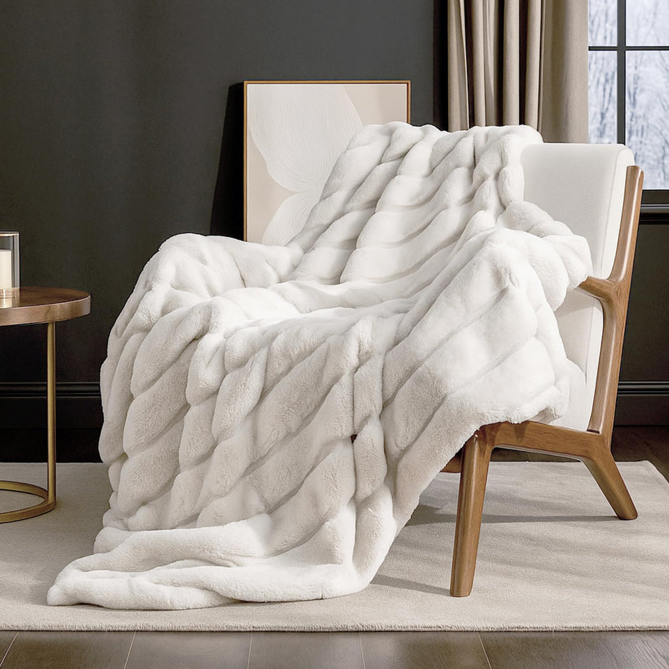 Cozy Bliss Deluxe sheared rabbit faux fur throw on a sofa adds cozy warmth.