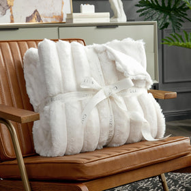 Cozy Bliss faux fur throw blanket on armchair adds comfort and style