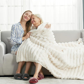 Cozy Bliss faux fur throw blanket on bed for cozy evenings