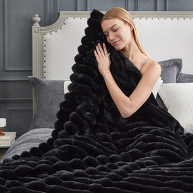 Cozy Bliss faux fur blanket in a bedroom setting for luxe lounging.