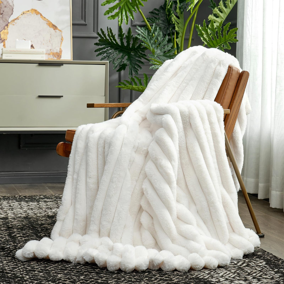 Folded Cozy Bliss faux fur throw blanket on ottoman decorating space