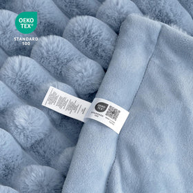 Cozy Bliss faux fur throw blanket in light blue color complements decor