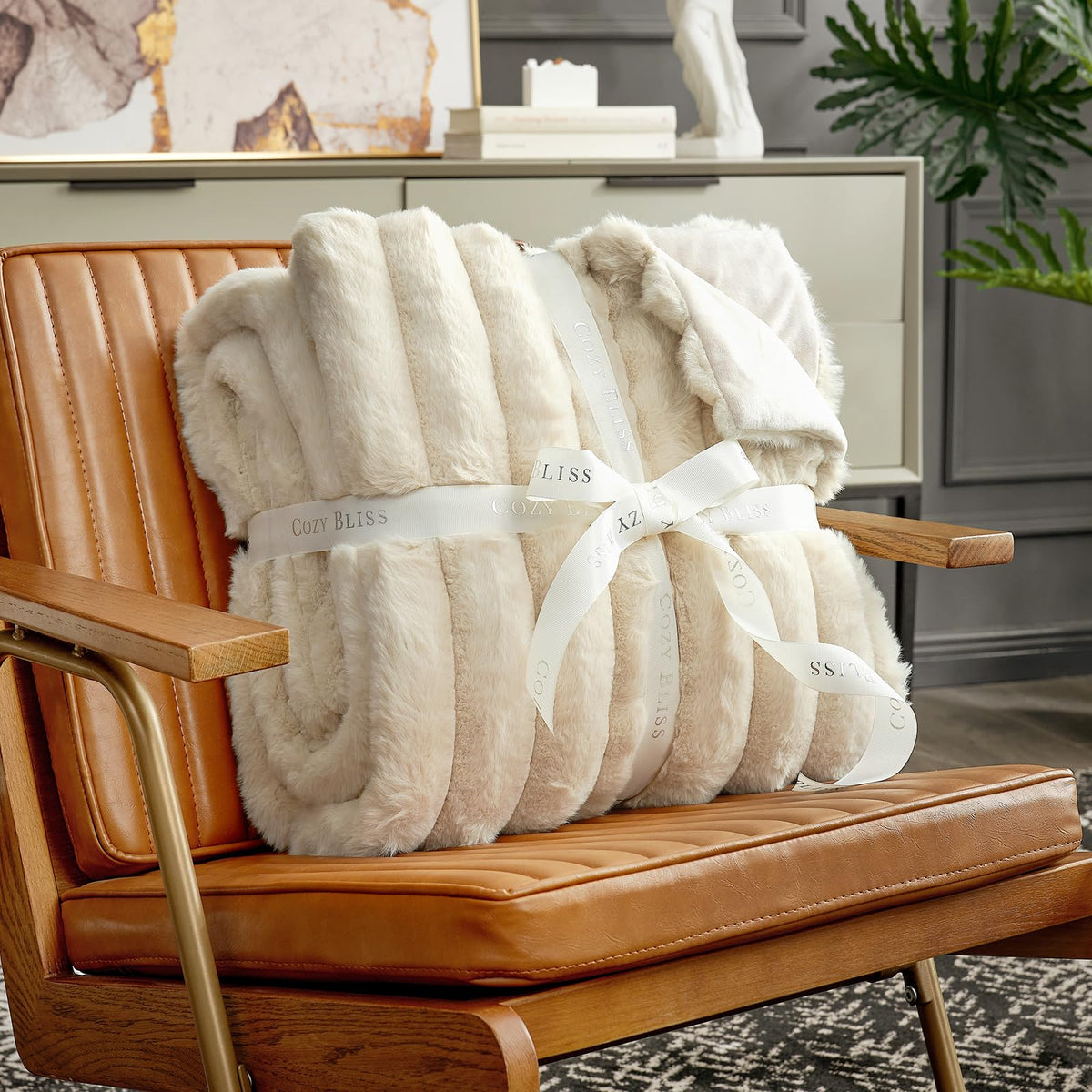 Cozy Bliss Faux Fur Throw Blanket on bed adds chic, cozy decor.