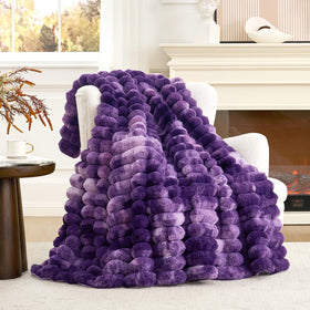 Cozy Bliss faux fur throw blanket on a sofa adds warm, inviting style.