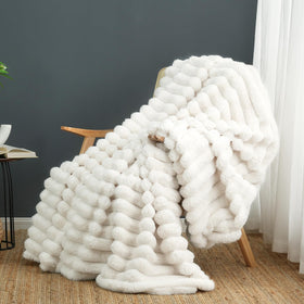 Cozy Bliss faux fur throw blanket on sofa for warm, inviting ambience
