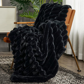 Cozy Bliss faux fur throw blanket on a sofa adds warmth and plush style.
