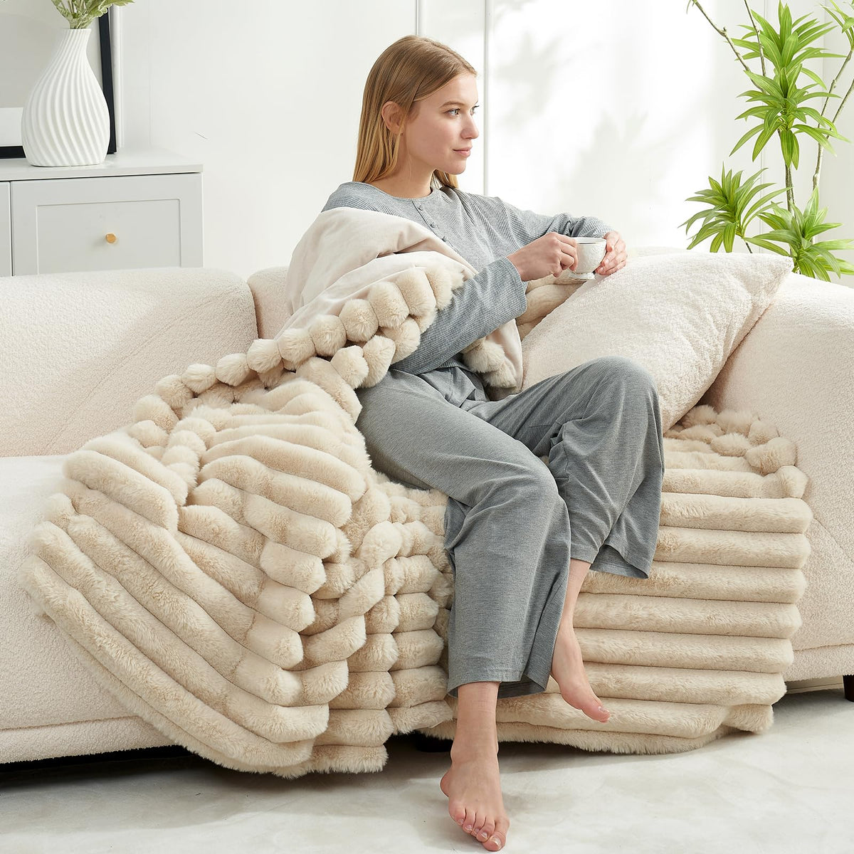 Cozy Bliss Faux Fur Throw Blanket soft plush fabric drape on a sofa.
