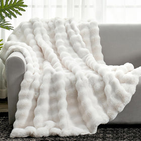Cozy Bliss faux fur throw face side in cream offers plush sofa comfort.