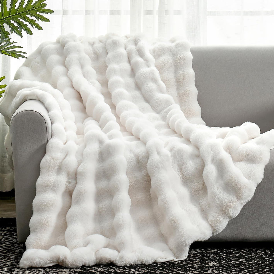 Cozy Bliss faux fur throw face side in cream offers plush sofa comfort.