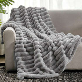 Cozy Bliss faux fur throw on sofa adds warmth and style.