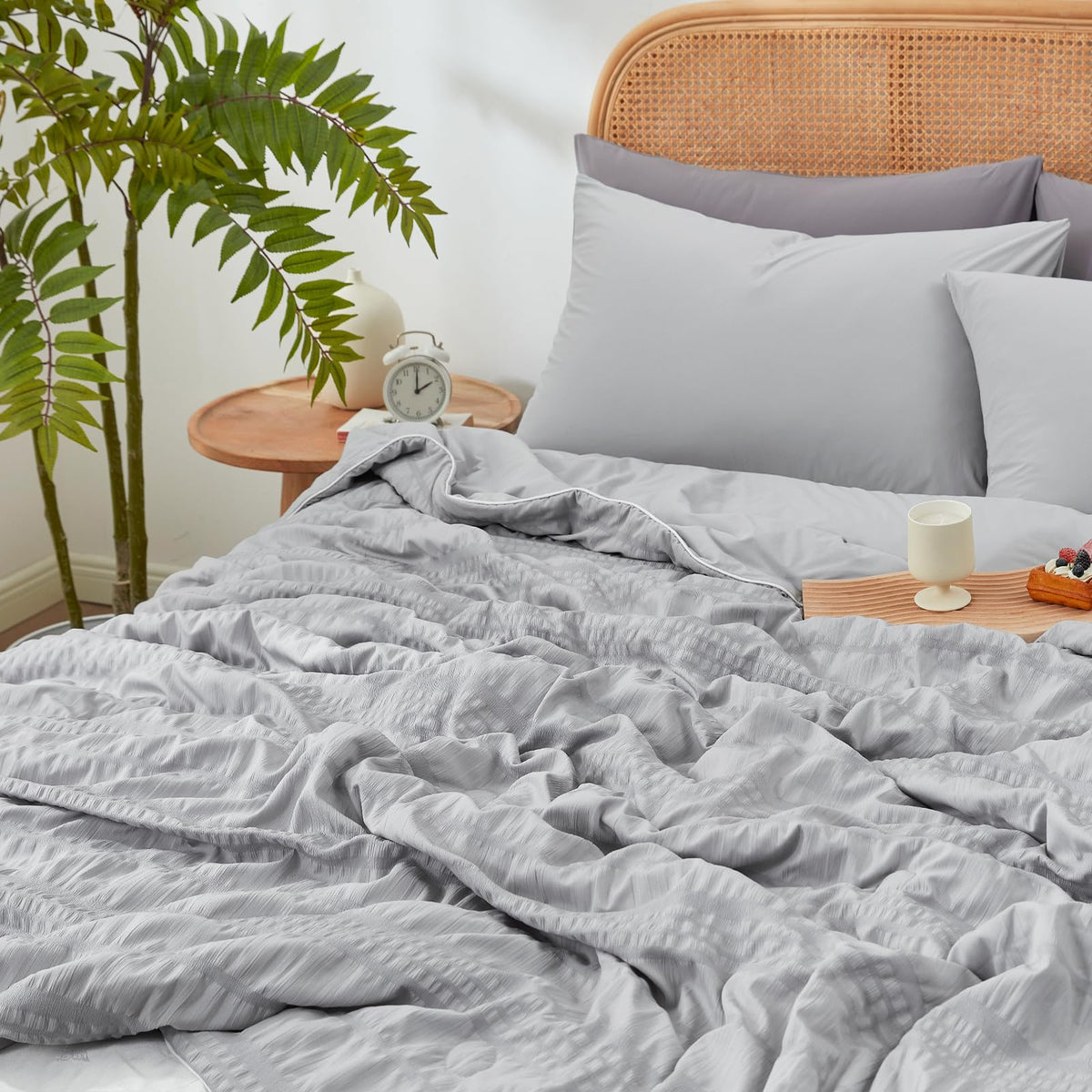 Cozy Bliss lightweight summer bedding folded on bed, ready for easy care and quick refresh