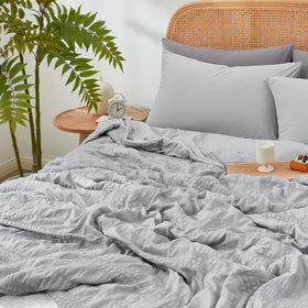 Cozy Bliss lightweight summer bedding folded on bed, ready for easy care and quick refresh