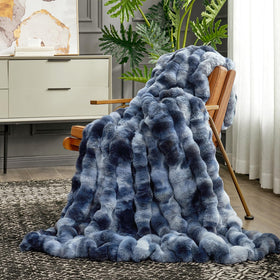 Cozy Bliss plush throw drapes over sofa for cozy relaxation.