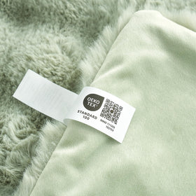Cozy Bliss sage green throw complements bedrooms with calm cozy aesthetics.