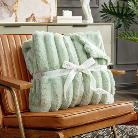 Soft sage-green Cozy Bliss blanket enhances bedroom decor and comfort