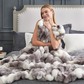 Cozy Bliss bubble-design throw complements decor and adds visual depth.